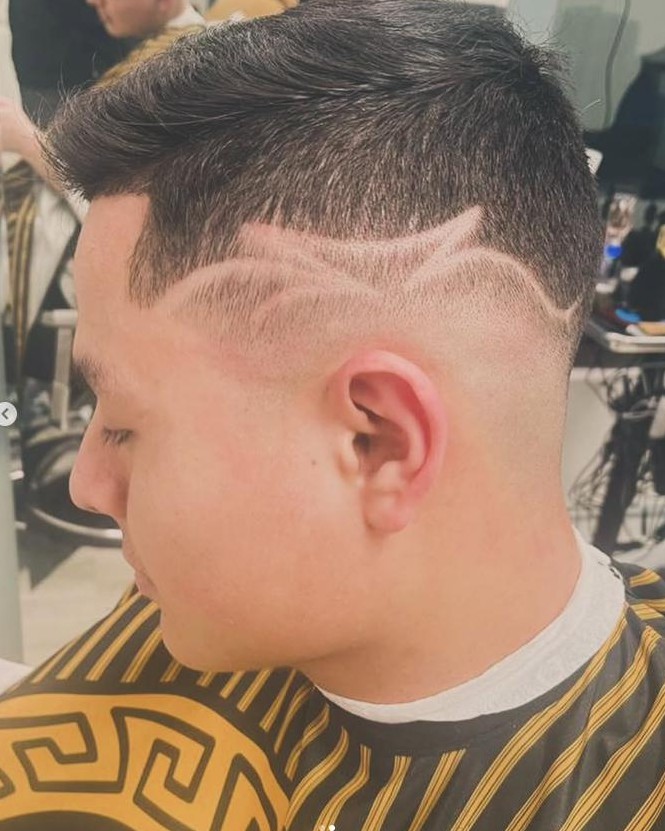 Skin fade with a freehand design line at Unlimited Barbershop in Danbury, CT